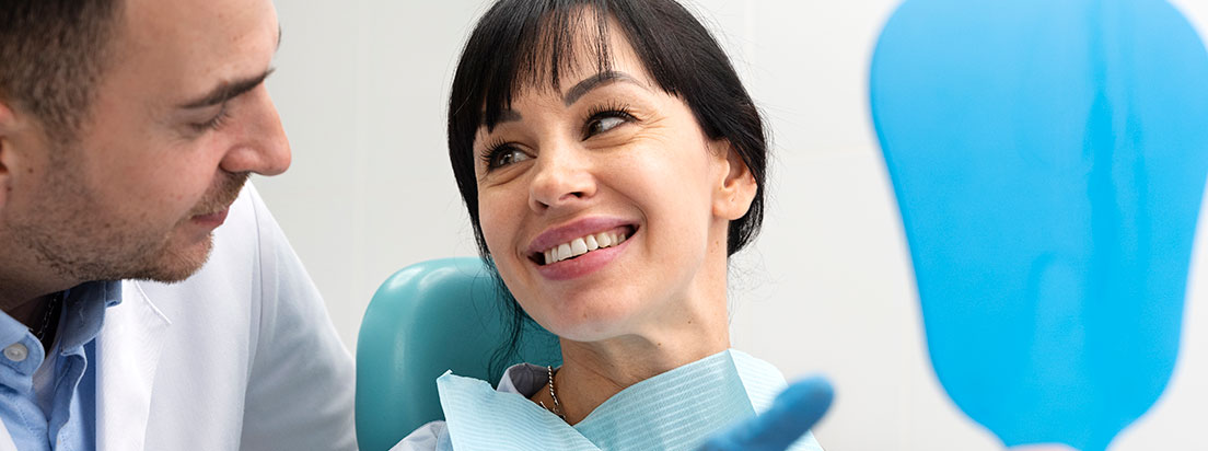 Westgrove Dental - Woman sitting in dental chair smiling at doctor